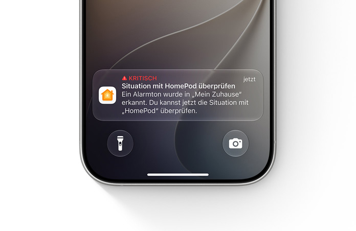 Ein iPhone Sperrbildschirm zeigt eine wichtige Mitteilung in der Home App an, Text: Dringlich, Situation mit HomePod überprüfen, Ein Alarm wurde in deinem Zuhause erkannt, Du kannst die Situation jetzt mit dem HomePod überprüfen