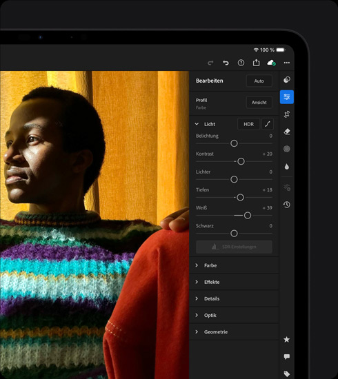 iPad Pro, Vorderansicht, Querformat, Farbe Space Schwarz, das Display zeigt das Bearbeiten eines Fotos von einer Person in einem bunten Pullover, rechts ist ein Menü mit Tools und Effekten geöffnet