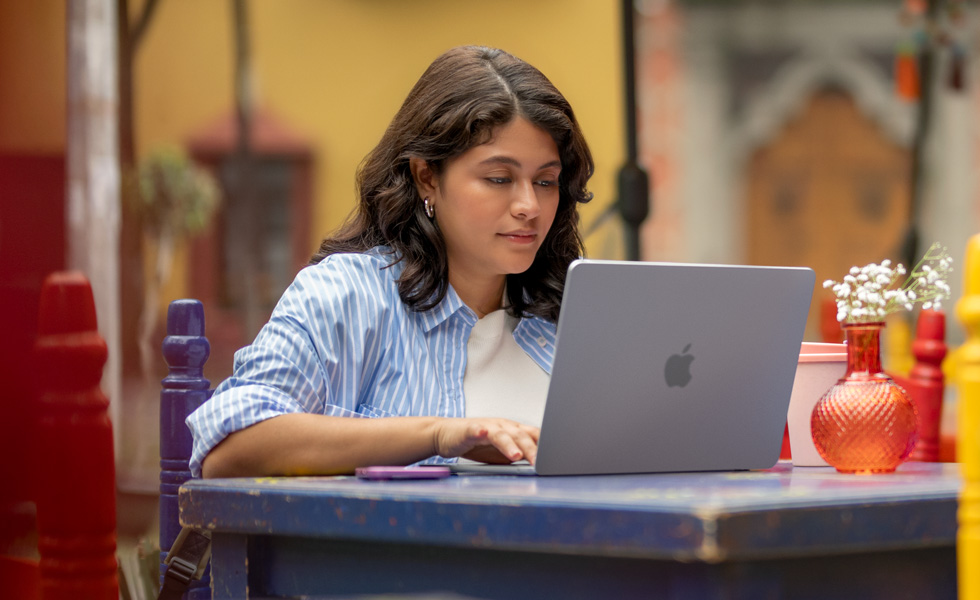 A student typing on her MacBook